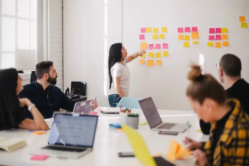 woman-placing-sticky-notes-on-wall woman-placing-sticky-notes-on-wall